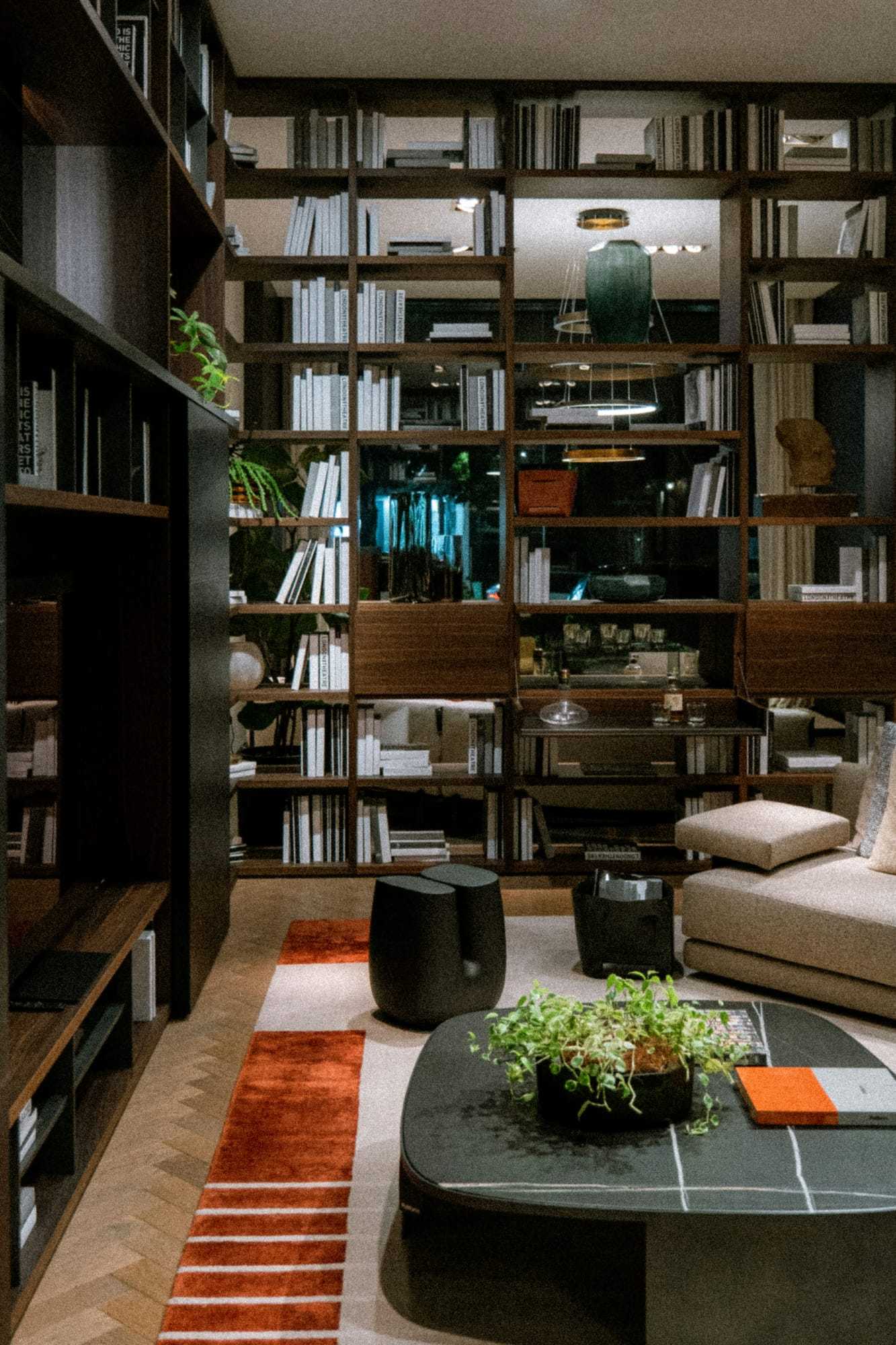 A living room with floor-to-ceiling shelving