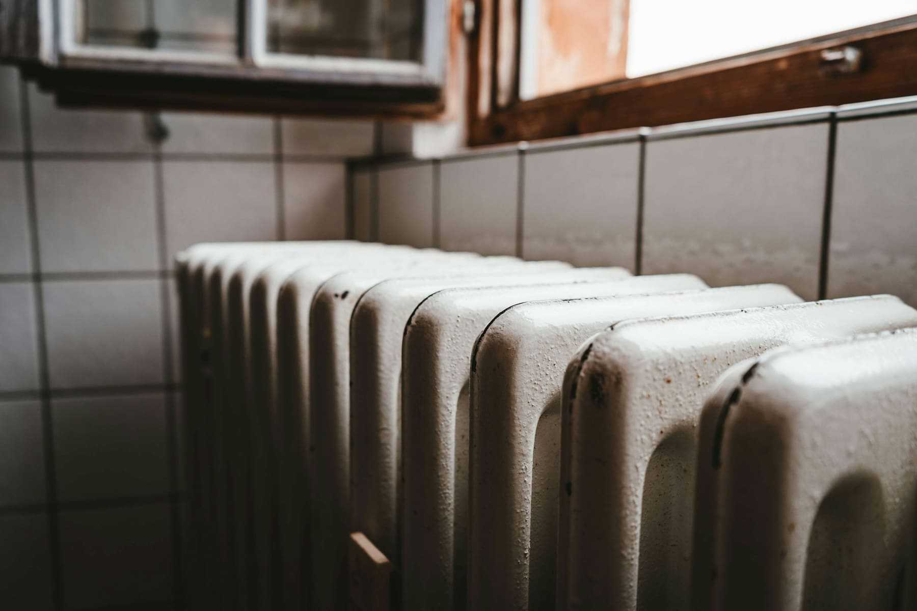 A cast-iron radiator under a window